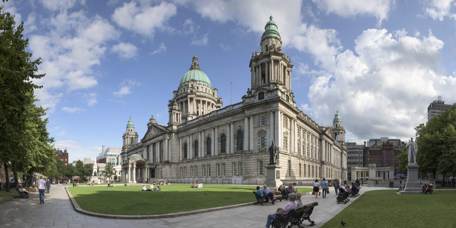 Belfast City Hall on a sunny day with people milling about outside