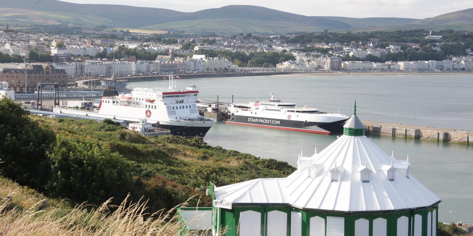 View of coastline with ferry's in the background anchored at port 