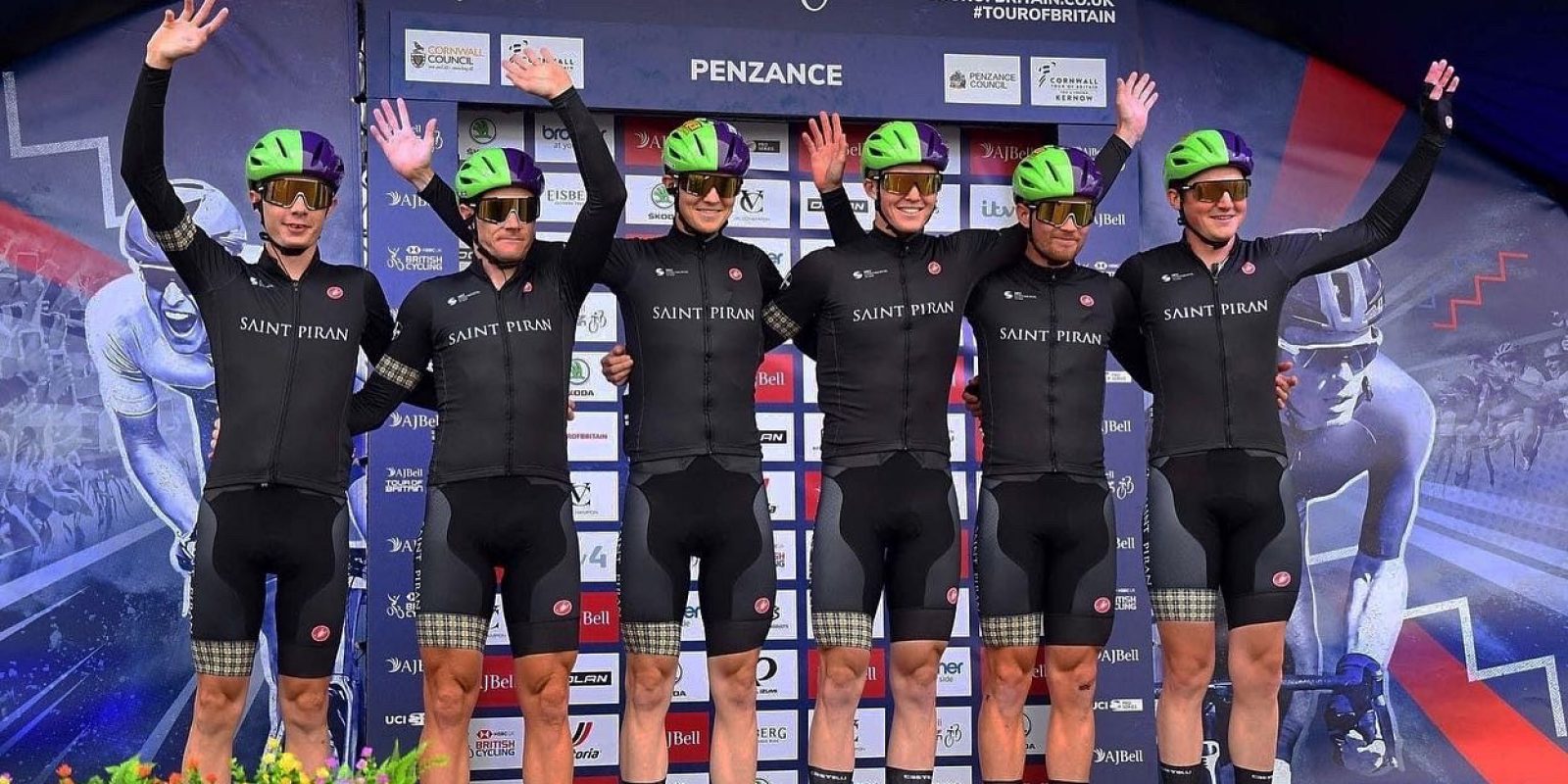 Saint Piran Pro Cycling Team waving in green and purple helmets