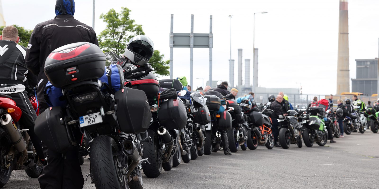 Large group of bikers and their bikes lined up